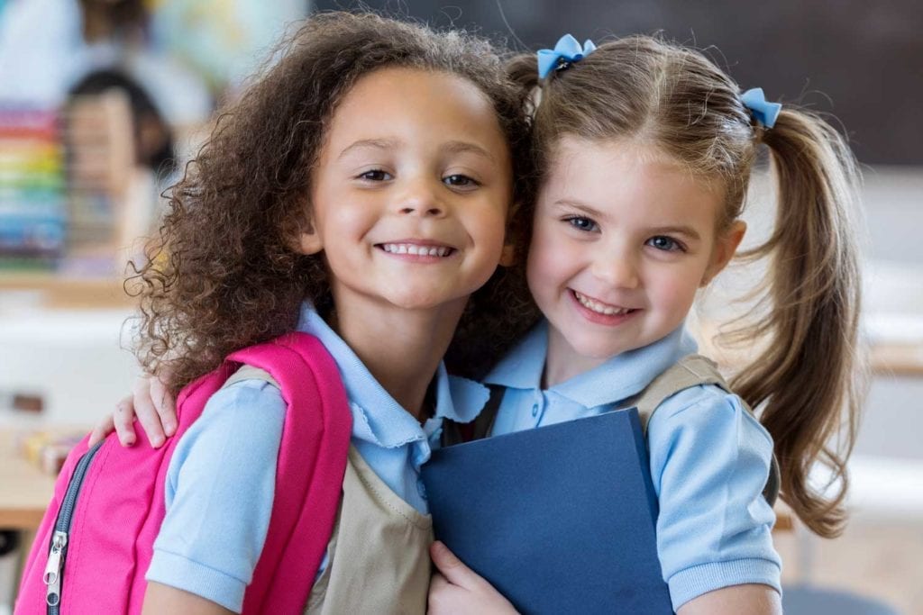 Preschool friends with backpack and book