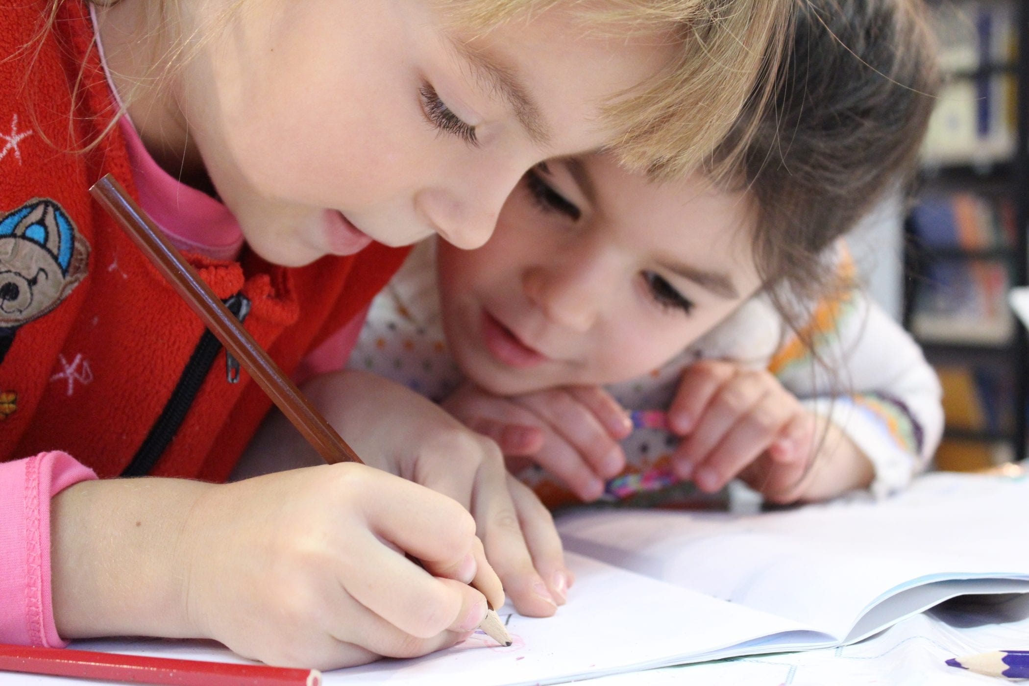Child at desk writing in notebook