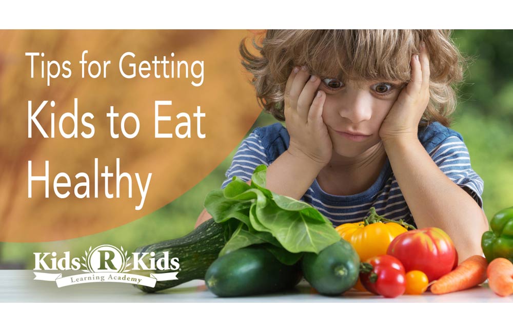 Blog image of child looking at vegetables on a table