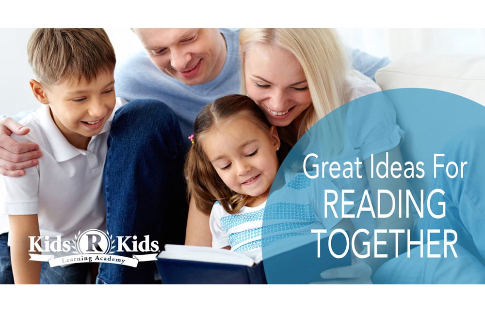 Parents and two children reading a book together
